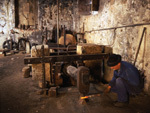 An ironsmith at work in an old mallet
